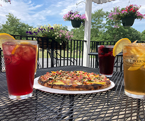 Drinks and a pizza on a table at DuBois Farms.